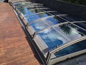 Photo of a pool with a newly built low swimming pool enclosure